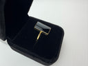 Black onyx rectangle ring with 18K gold plated brass bezel setting displayed in a black velvet jewelry box, top view.