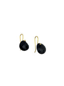 Black onyx checker cut heart drop earrings with gold hook closures laid flat on a light grey surface, showing the faceted stone detail and gold bezel setting.