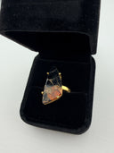 orange and black Mojave copper turquoise ring showing the dramatic triangular freeform stone in a gold plated brass prong setting with adjustable band