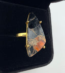 orange and black Mojave copper turquoise ring showing the dramatic triangular freeform stone in a gold plated brass prong setting with adjustable band