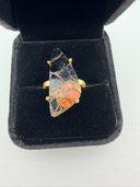 orange and black Mojave copper turquoise ring showing the dramatic triangular freeform stone in a gold plated brass prong setting with adjustable band