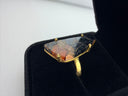 orange and black Mojave copper turquoise ring showing the dramatic triangular freeform stone in a gold plated brass prong setting with adjustable band