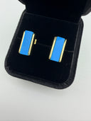 urquoise bar stud earrings with 18K gold plated brass frame displayed in a black velvet jewelry box. The earrings feature a smooth rectangular natural turquoise gemstone set between two polished gold rails.