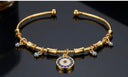 gold charm protection bracelet with evil eye symbols