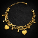 Onyx Double Chain Love Bracelet in gold with layered chains and heart charms on dark background