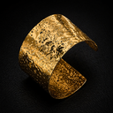 Onyx Hammered Cuff Bracelet in gold with wide textured surface on dark background