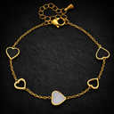 Onyx Black Heart Chain Bracelet in gold with black and white heart details on delicate chain against dark background