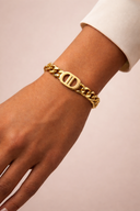 Onyx Cuban Link Bracelet in gold with chunky chain links worn on wrist against dark background