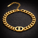 Onyx Cuban Link Bracelet in gold with chunky chain links worn on wrist against dark background