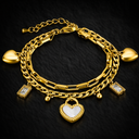 Onyx Double Chain Crystal Heart Bracelet in gold with layered chains, heart charms and cubic zirconia details on dark background