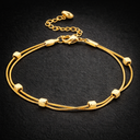Onyx Double Snake Chain Bracelet in gold with two fine chains and bead accents on dark background
