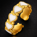 Onyx Heart Ring White in gold with enamel heart details on adjustable band against dark background