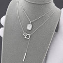 Silver geometric lariat necklace displayed with coordinating necklaces