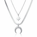 Layered stainless steel necklace with starburst and crescent pendants