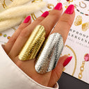 Silver and gold shield rings shown together for scale