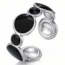 Polished stainless steel adjustable statement ring with black enamel circles