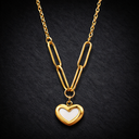Onyx Paperclip Heart Necklace in gold with elongated chain links and small heart pendant on dark background