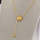 Onyx Sphere Drop Necklace displayed on a jewellery stand