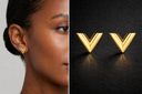 Onyx V Stud Earrings in gold with sleek chevron design worn on ear and displayed on dark background